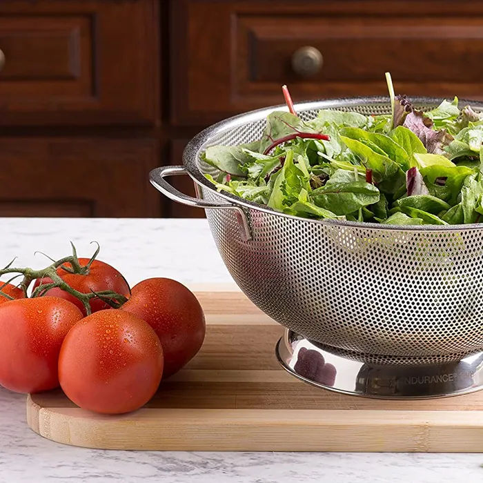 A colander full of greens: the piece that taught us how much a water spot shows on polished steel.