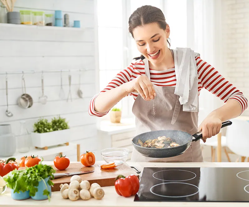 A cook at the stove: every tool we make is drawn for this moment, not for the shelf.